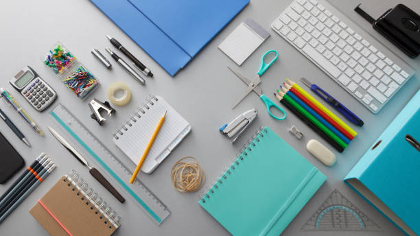Organized desk with notebooks, pens and office supplies